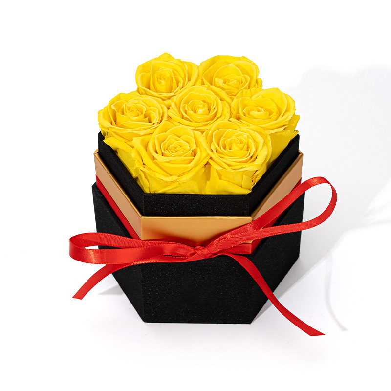 Bright yellow preserved rose hexagon gift box with satin red ribbon